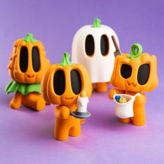 three plastic pumpkins with faces painted to look like they are holding something in their hands