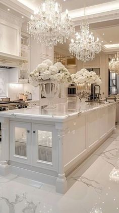 an elegant kitchen with chandelier and marble counter tops