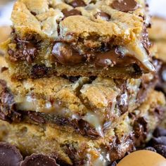 chocolate chip cookie bars stacked on top of each other with an egg in the background