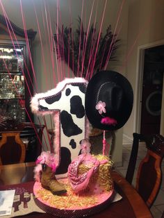 a cowgirl birthday cake with pink and black decorations