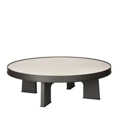 a round table with black legs and a white top