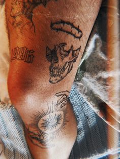 a man's arm with tattoos on it