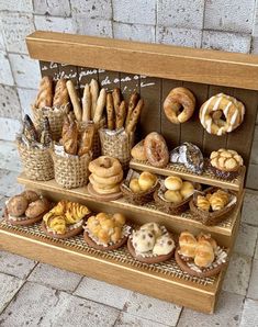 a display case filled with lots of different types of doughnuts and pretzels