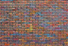 an old brick wall painted with multicolored paint