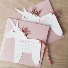 three pink and white llama shaped wedding cards