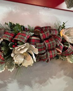 a christmas garland with poinsettis and greenery