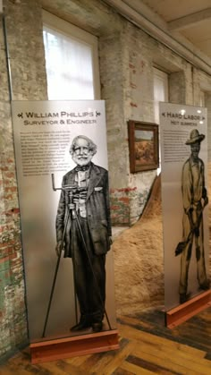 two display boards with pictures of people in old fashion clothing and hats on them, along with wooden flooring