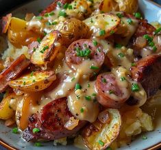 a white plate topped with potatoes and sausage covered in gravy