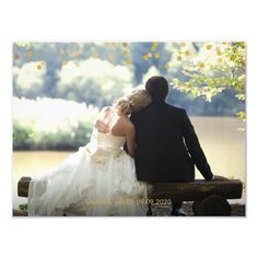 a bride and groom sitting on a bench