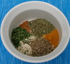 a white bowl filled with different types of spices