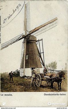 an old photo of a windmill being pulled by a horse