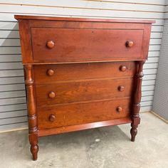 an old wooden dresser sitting in front of a wall