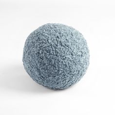 a blue ball sitting on top of a white floor