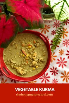 a bowl of vegetable kurma next to a potted plant