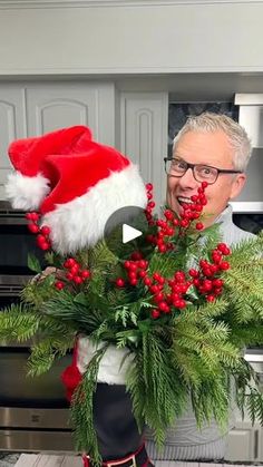 a man in a santa hat holding a bouquet of flowers