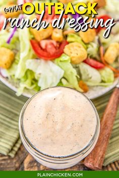 a salad with ranch dressing in a glass jar