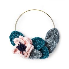 a crocheted headband with flowers on it