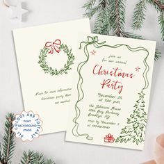 two christmas party cards sitting on top of a table