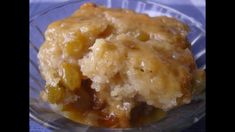 a close up of a piece of food in a glass bowl on a blue table cloth