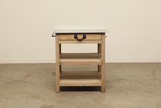 a small wooden table with two drawers on one side and an open drawer on the other