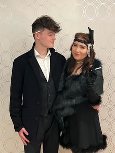 a young man and woman dressed up in formal wear