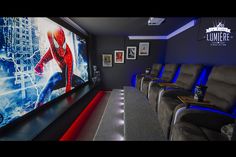 a home theater with blue lighting and chairs