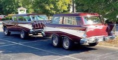 two old cars parked in a parking lot