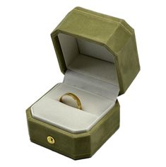 an open green box with a gold ring inside