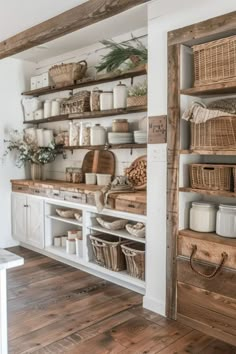 the shelves in this kitchen are filled with wicker baskets and other things to put on them