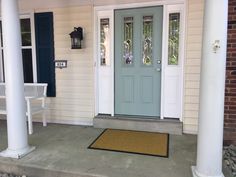 the front door of a house with blue shutters