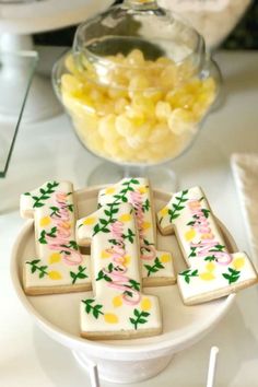 decorated cookies are on a plate with candy in the background