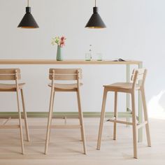 two wooden stools sitting next to a table