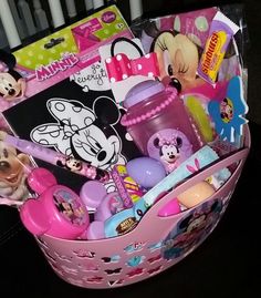 a pink basket filled with lots of toys