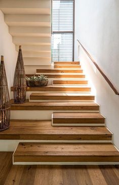 the stairs are made of wood and have metal handrails on each one side