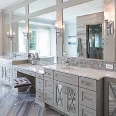 a large bathroom with double sinks and mirrors