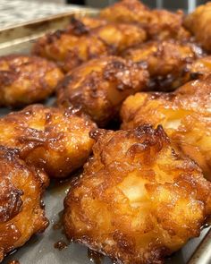 some fried food is sitting on a tray and ready to be cooked in the oven