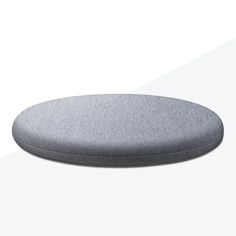 a round gray cushion sitting on top of a white floor