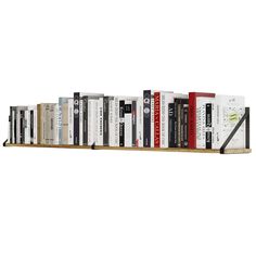 a bookshelf filled with lots of books on top of each other in front of a white wall