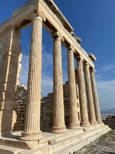 the ruins of an ancient greek temple against a blue sky