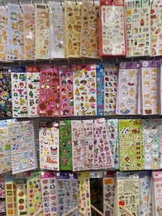 there are many different stickers on display in the store, including hello kitty and other items