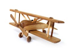 a wooden model of an airplane with the leftover materials logo above it