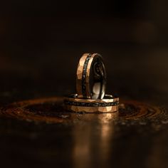 two wedding rings sitting on top of each other