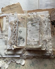 an open book with lace and paper on it