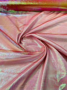 a pink and gold fabric with metallic foil on the bottom, as well as an orange stripe