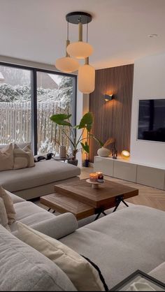 a living room filled with furniture and a flat screen tv mounted to the side of a wall