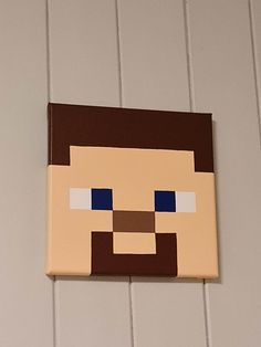 a wooden block with a face on it