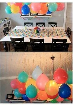 balloons are hanging from the ceiling above a dining room table