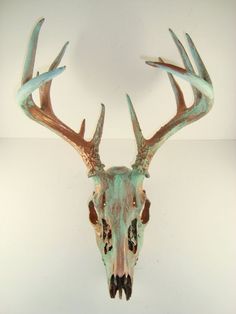 a deer's head with antlers is shown against a white background and it appears to be made out of metal