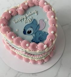 a pink and white birthday cake with an image of stitching stitchs on it