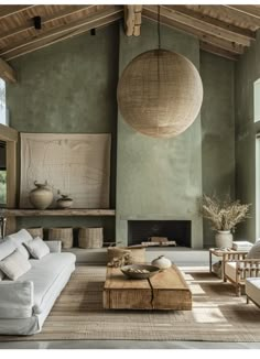 a living room filled with furniture and a large round light fixture hanging from the ceiling